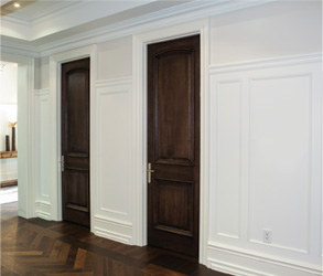 two dark wood interior panel doors in a white wall