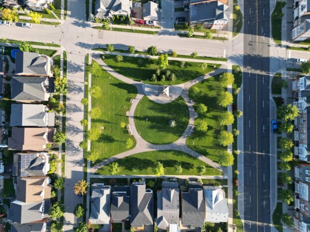 Aerial view of a vibrant Markham neighborhood showcasing well-manicured lawns, tree-lined streets, and modern homes.