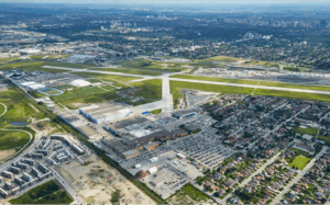 Aerial view of Downsview in Toronto, showcasing Downsview Park’s greenery and nearby residential neighborhoods under clear skies.